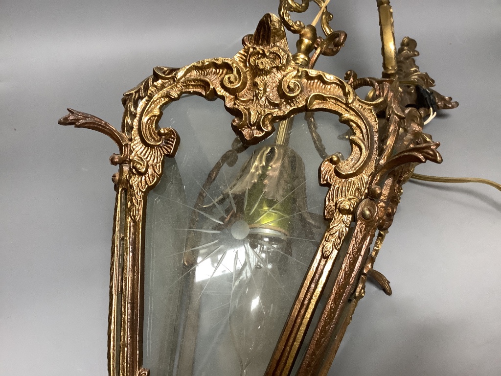 A brass hanging lantern and bracket